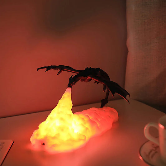 3D printed fire dragon lamp glowing on gaming desk.