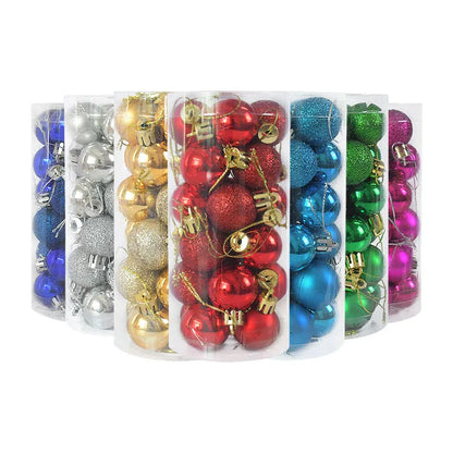 Shiny red and gold Christmas ornaments on pine branches.